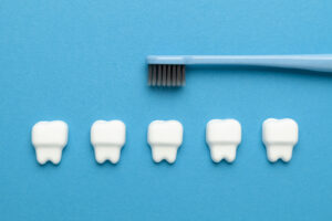 Teeth and toothbrush on a blue background